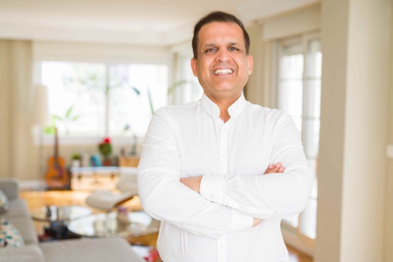 Middle age man smiling confident to the camera at home