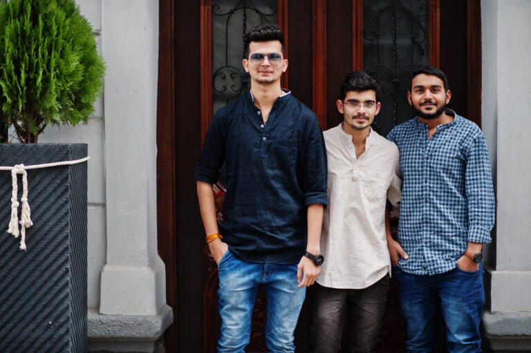 Three roommates outside their flat
